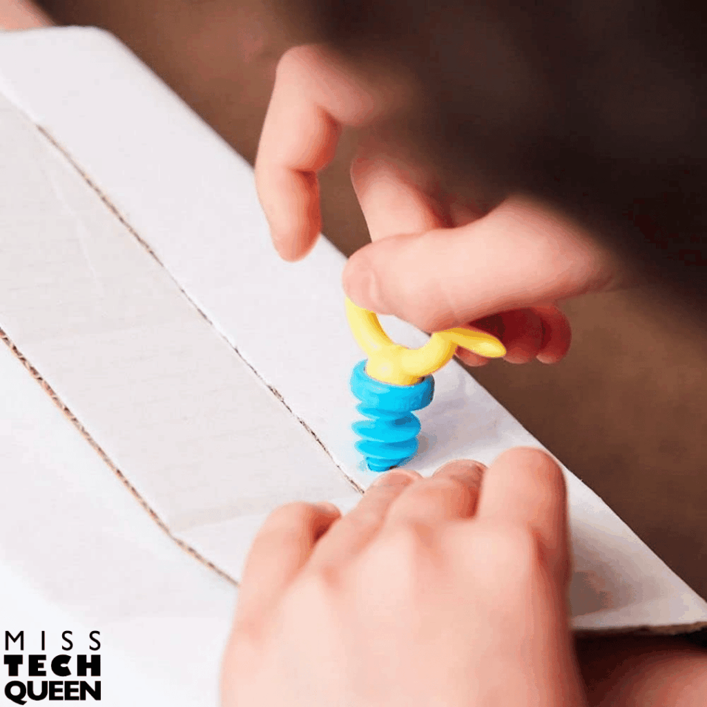 Makedo tools allow students to safely connect cardboard pieces to build prototypes and inventions.